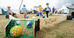 Kinder spielen auf einem Festival mit der Ballbandde